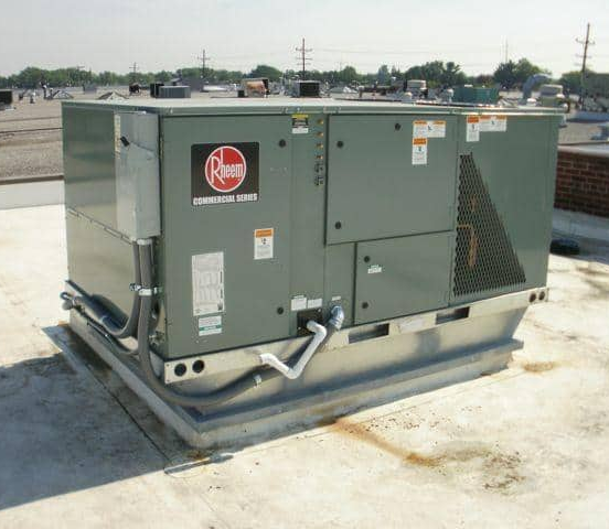 Experienced HVAC technician testing airflow and system performance with professional diagnostic tools
